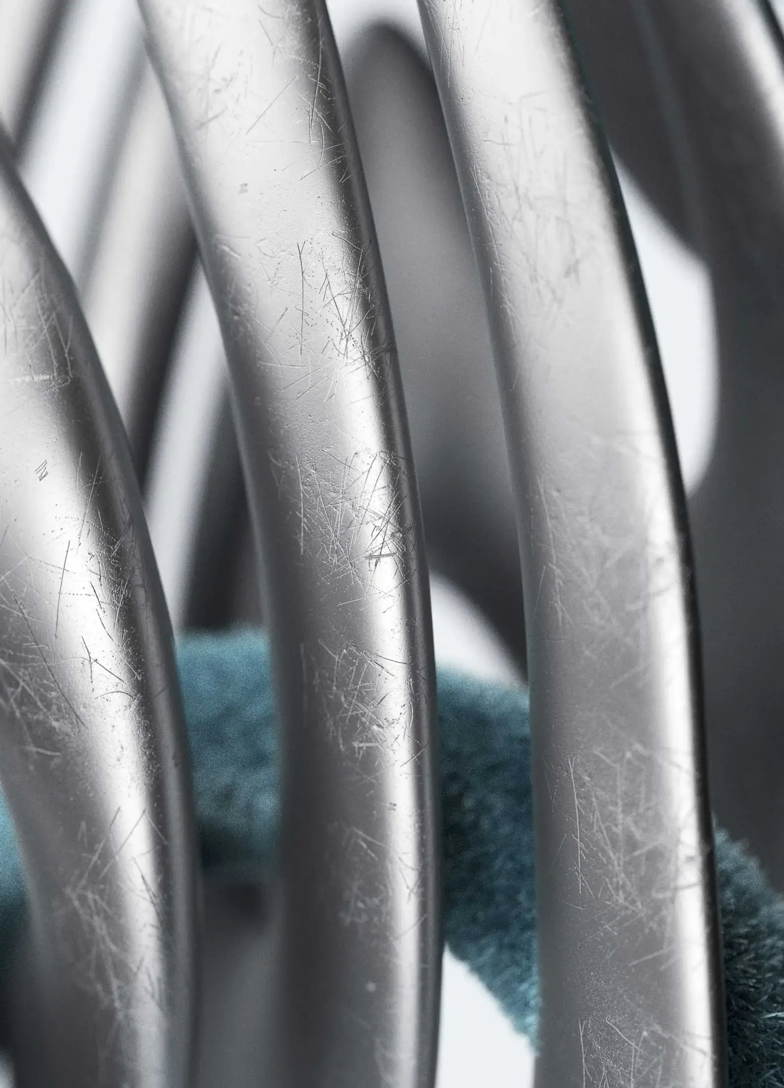 Close-up of the scratched metallic surface of Apple’s brand avatar, showcasing wear and tactility as symbolic material memory.
