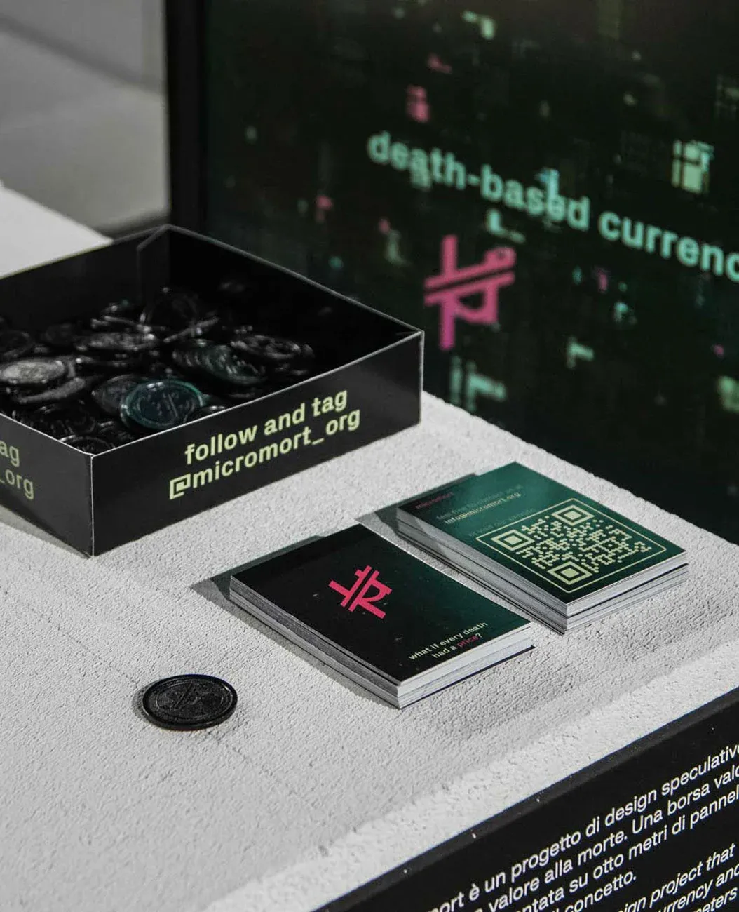 Micromort currency coins and printed materials on display at the Lost Graduation Show during Supersalone 2021, Milan Design Week