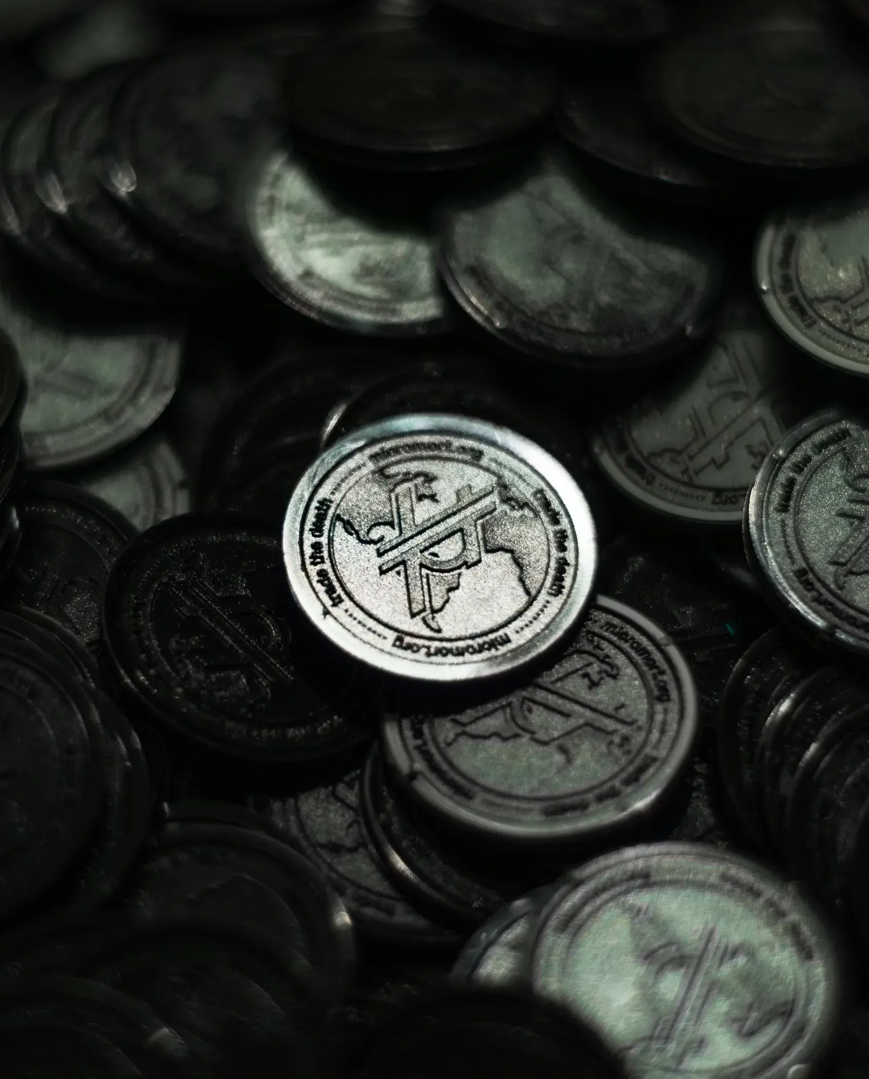 Custom-designed Micromort coins showing logo