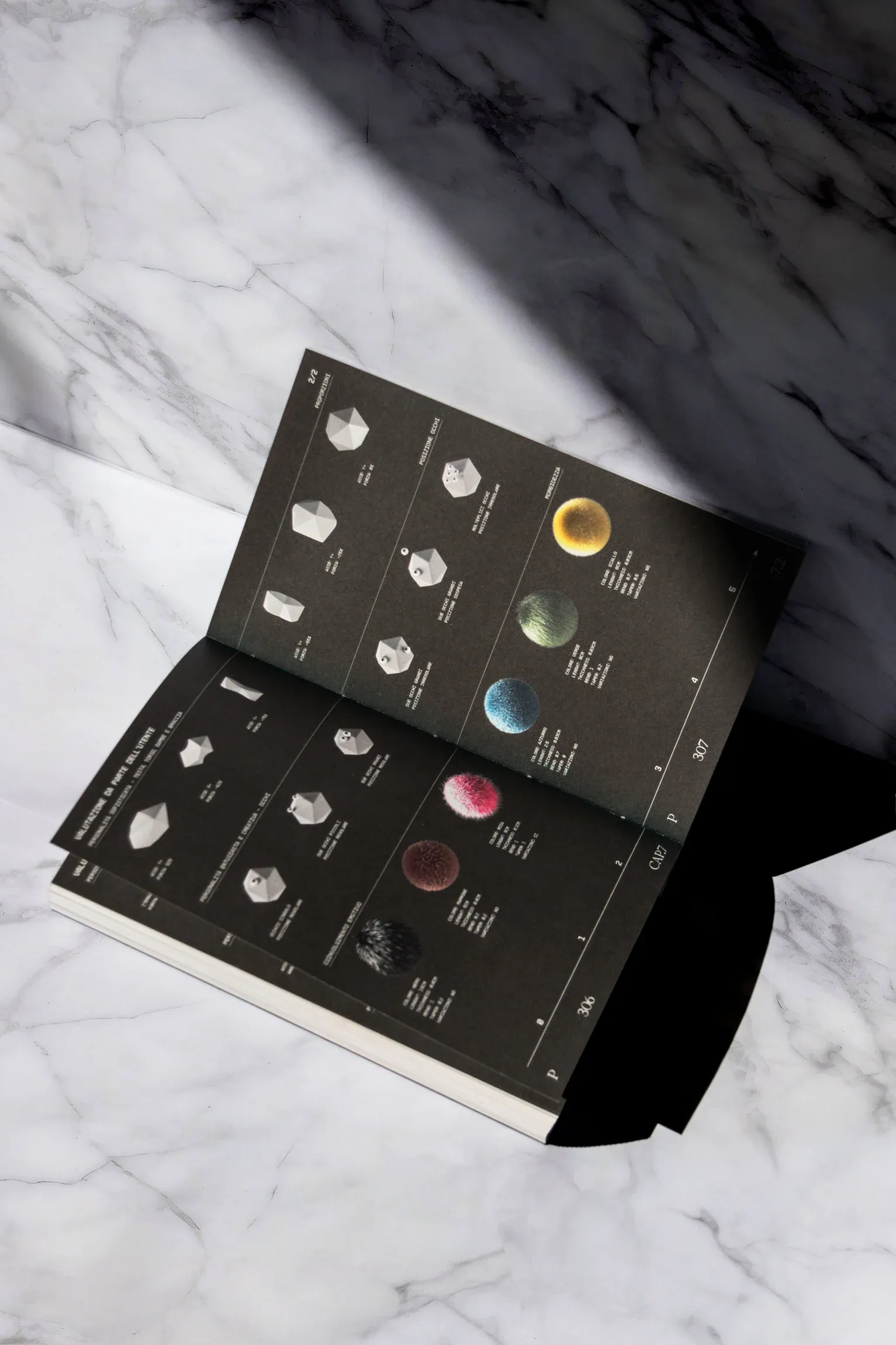 Photograph of the speculative thesis book showing a table that details the parametric system for avatar generation, including base shapes, perceptual cues, and texture mappings | Carlotta Bacchini