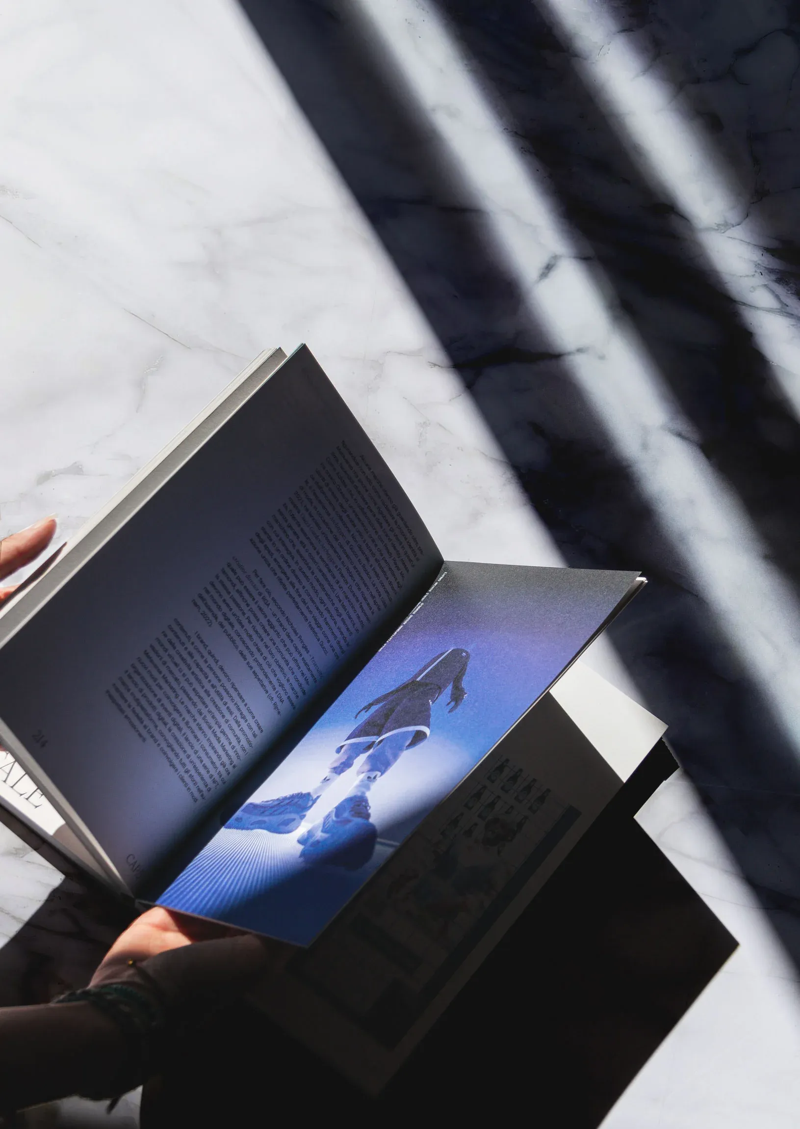 Open thesis book displaying Adidas Ozworld case study with digital avatar and explanatory text