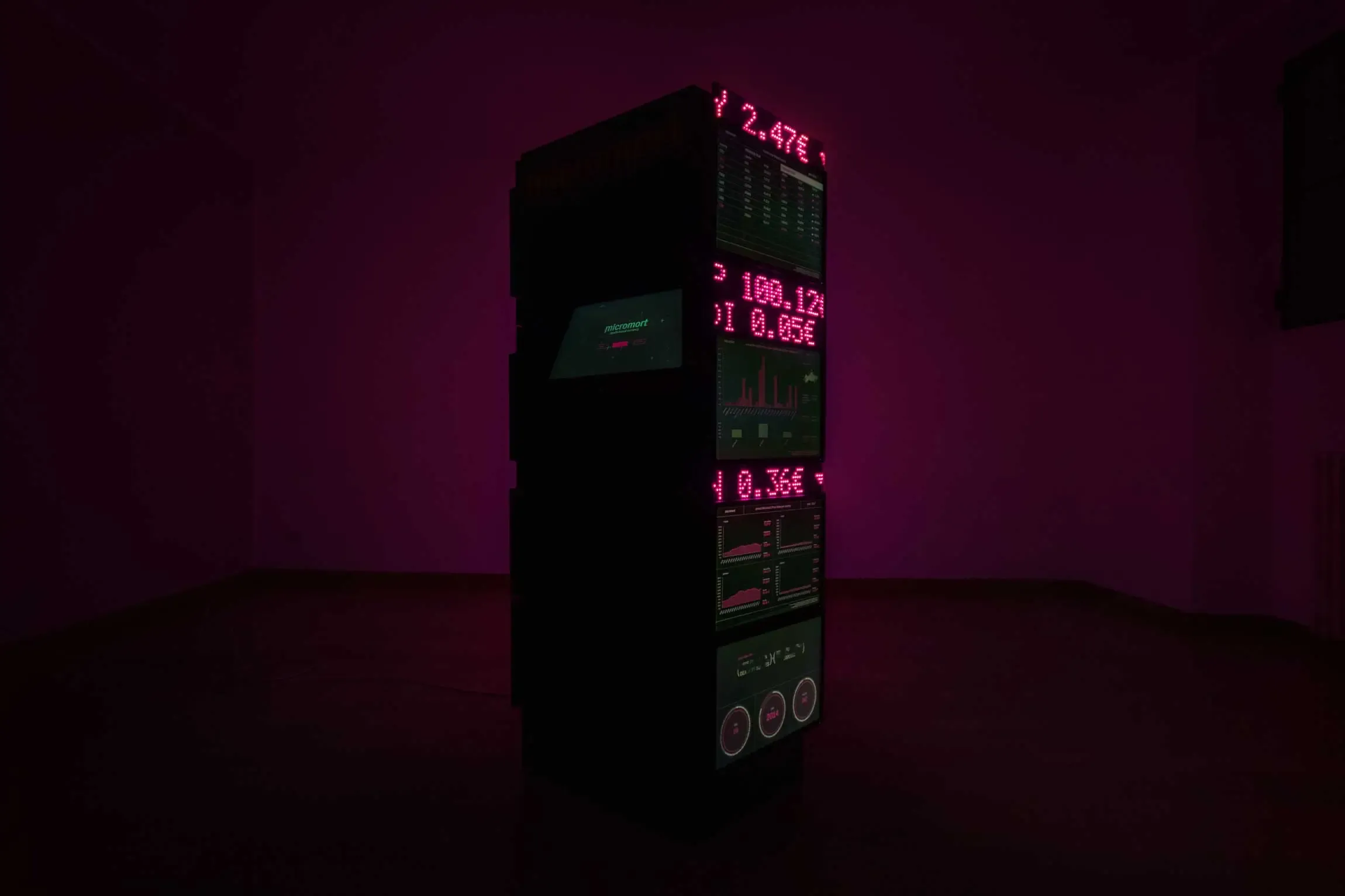 Full view of Micromort speculative design installation totem composed of LED matrix displays and monitors>
<!-- <p class=